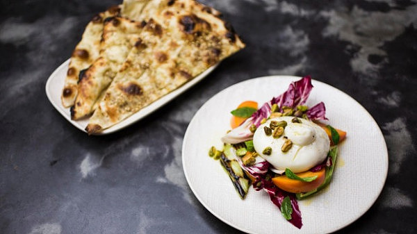 Go-to dish: Clay oven flat bread with burrata, persimmon and grilled leeks.