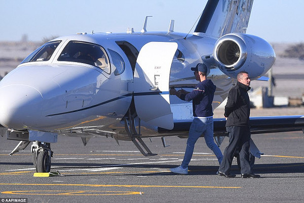 Curtis is pictured holding his arms open as he walks up to his chidlren, who are on the family's private plane