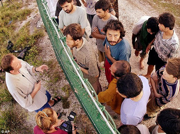 The Australian government pays Nauru and Papua New Guinea to house asylum seekers in conditions condemned by human-rights groups (file photo of asylum seekers on Nauru speaking with journalists in 2001)