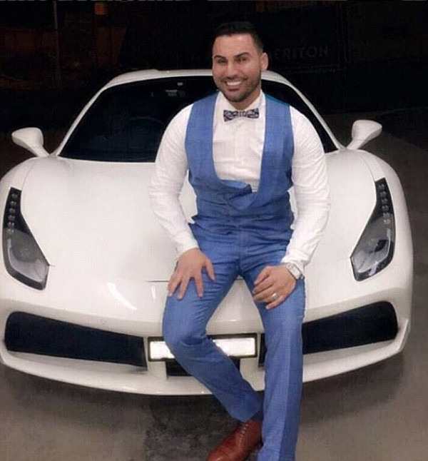 The 31-year-old is known for flaunting his 'wealth' (he is pictured posing in front of a Porsche)  