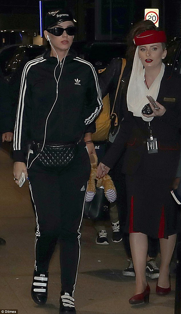 Keeping a low profile? Daily Mail Australia has obtained photographs of Katy, 32, casually strolling through the airport terminal with her entourage at 7:30pm on Sunday