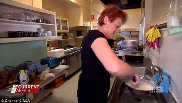Pauline Hanson mixes up some potato scallops batter as she helps a Queensland shop