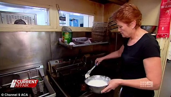 The One Nation leader grabbed some tongs and put the potato scallops into some hot oil
