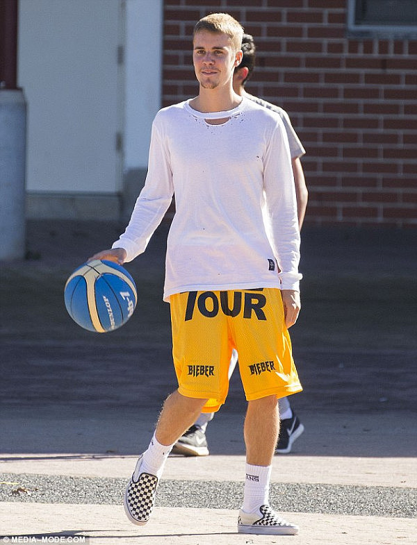 Playing ball: Later in the day, Justin worked up a sweat, playing basketball at Sydney Olympic Park with friends