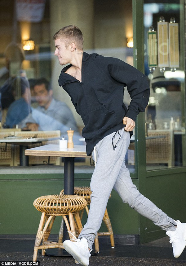 Doing a runner: Justin excited breakfast in a hurry putting his white sneakers to good use 