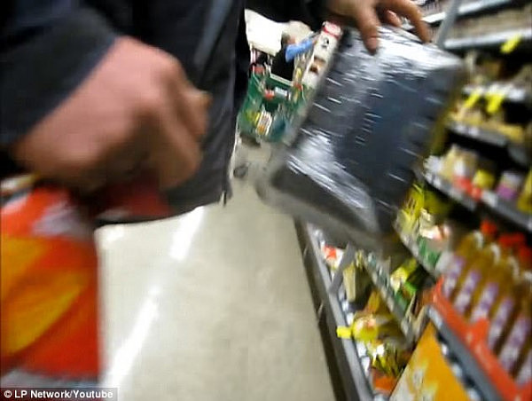 The bizarre moment a Queensland man attempted to steal an $8 pack of Woolworths sausages by shoving them down his pants (pictured) was caught on camera