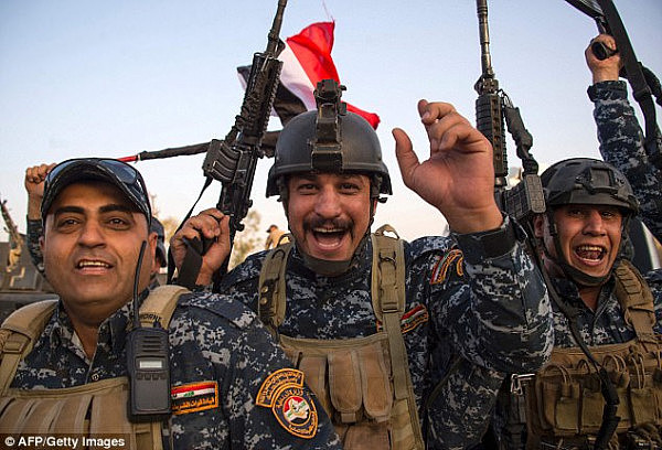 Members of the Iraqi federal police forces celebrate in the Old City after the government declared victory