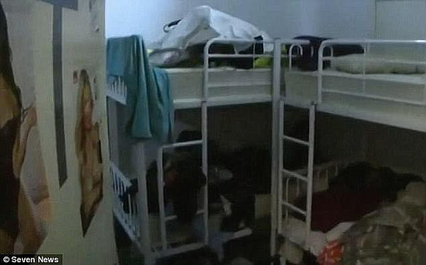 Photo obtained of an advertised share room, obtained by Channel Seven, shows clothes strewn across the room, and bunk beds connected in groups of four 