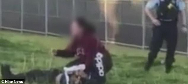 Video footage has captured the dramatic arrest of a Sydney woman who was tackled by police while holding a knife to a 13-year-old boy’s throat on Wednesday (pictured)