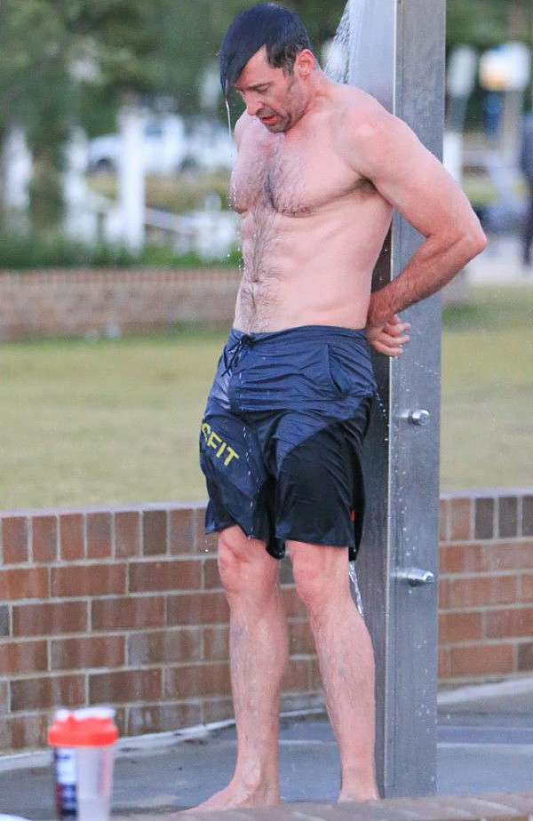 Hugh Jackman showering off after taking a quick dip at the beach. Picture: Matrix Media