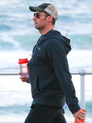 Taking a stroll along the beach with protein shake in hand. Picture: Matrix Media