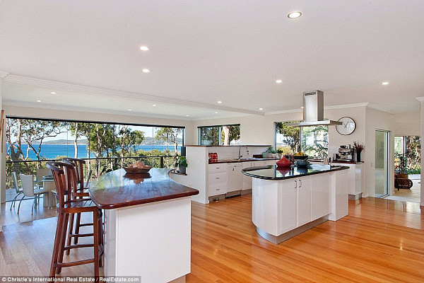 The trophy home is centred around a large kitchen (pictured) with two pantries, and has 180 degree panaromic views of the ocean