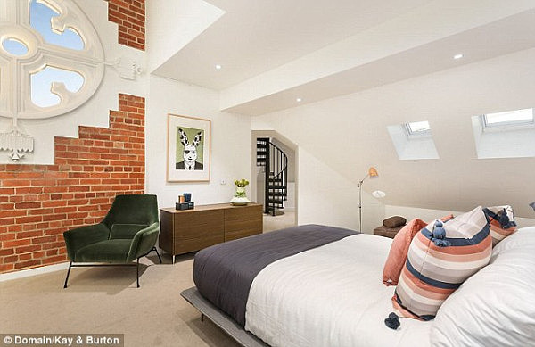 The main bedroom boasts a unique circular, clear-glassed window with stone-worked edging