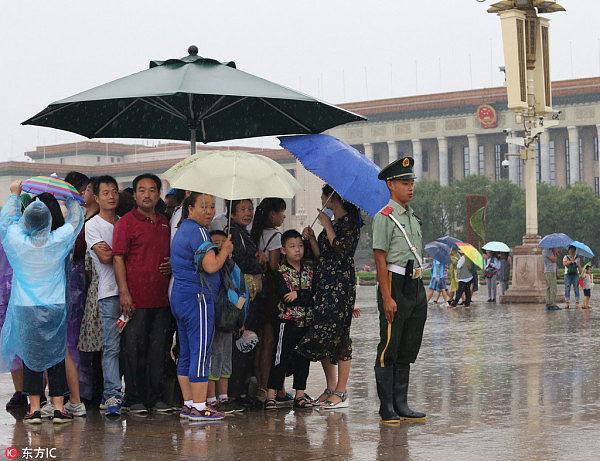 天安门广场哨兵给游客让伞 照片刷爆朋友圈（图） - 1