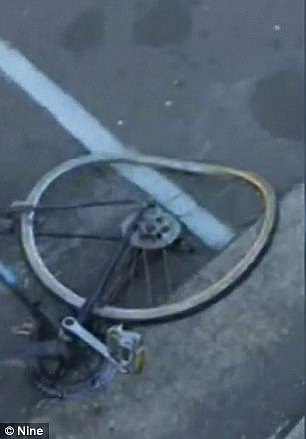 The clip ends with a shot of the cyclist's crumpled bike while the driver returns to his vehicle
