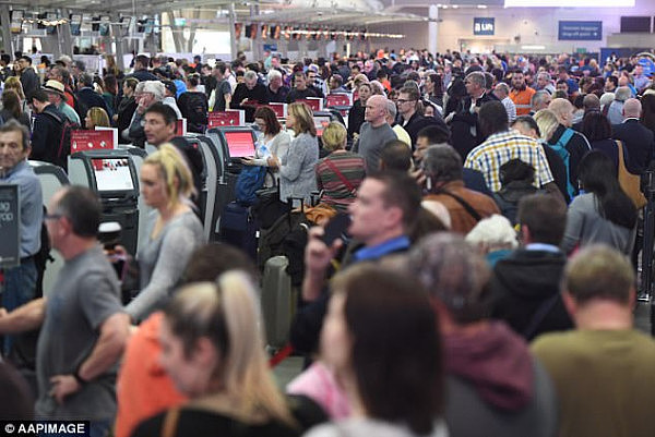 Independent Senator Nick Xenophon wants new rules ensuring airport workers go through the same checks conducted on passengers (pictured are passengers queuing to go through airport security)