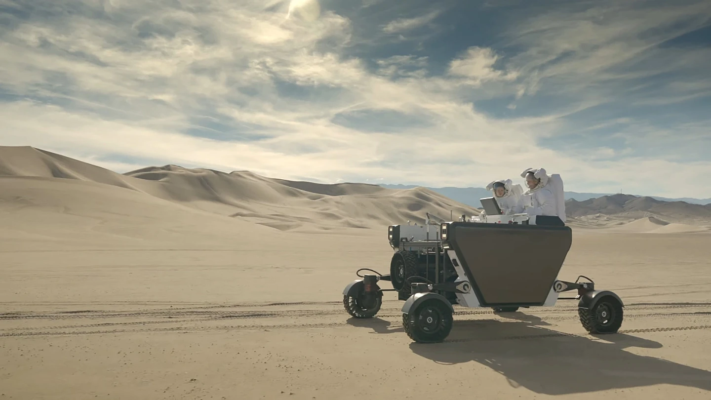 astronauts-riding-flex-rover.webp