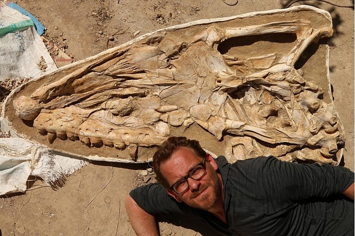 Nick-Longrich-With-Mosasaur-Fossil-scaled.jpg