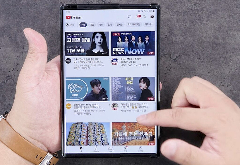 LG Rollable in hand with display extended and Youtube open on screen
