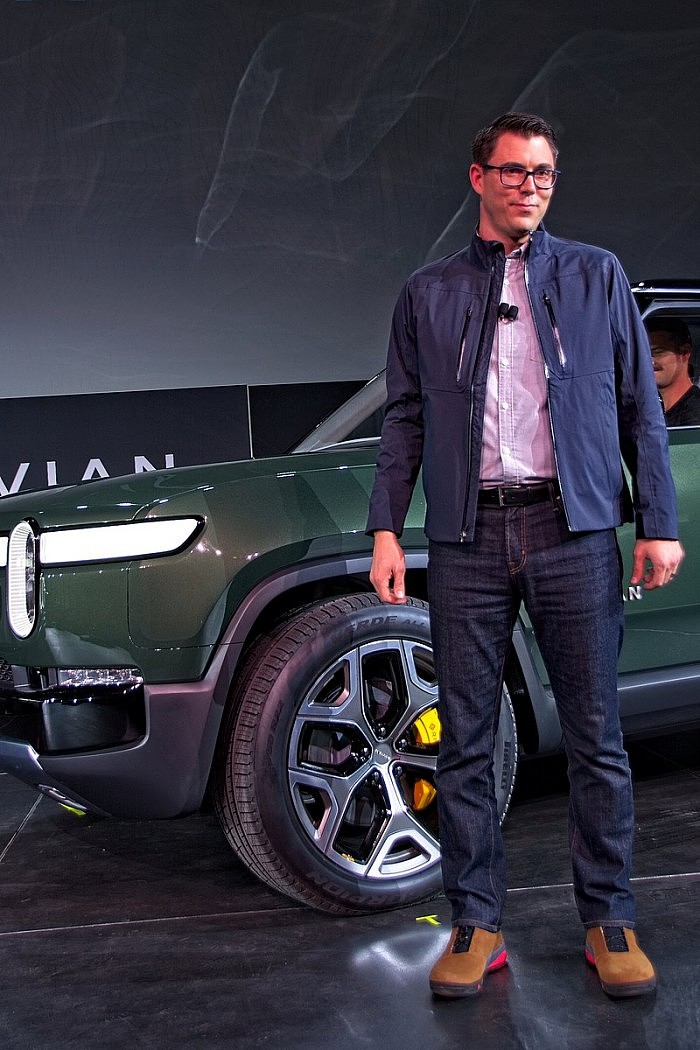 800px-Rivian_founder_and_CEO_Robert_'RJ'_Scaringe_at_the_debut_of_the_Rivian_R1S_SUV_at_the_2018_Los_Angeles_Auto_Show,_November_27,_2018.jpg